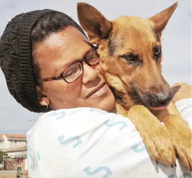  ??  ?? BESTIES: At the end of the process, elated pet owners such as Josephine Matroos, left, and Mauritia McKinnon are reunited with their furry friends.