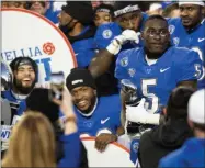  ?? JAKE CRANDALL - ASSOCIATED PRESS ?? Buffalo running back Kevin Marks ( 5) holds his trophy after being name MVP of the Camellia Bowl NCAA college football game in which Buffalo defeated Marshall 17- 10in Montgomery, Ala., on Friday.