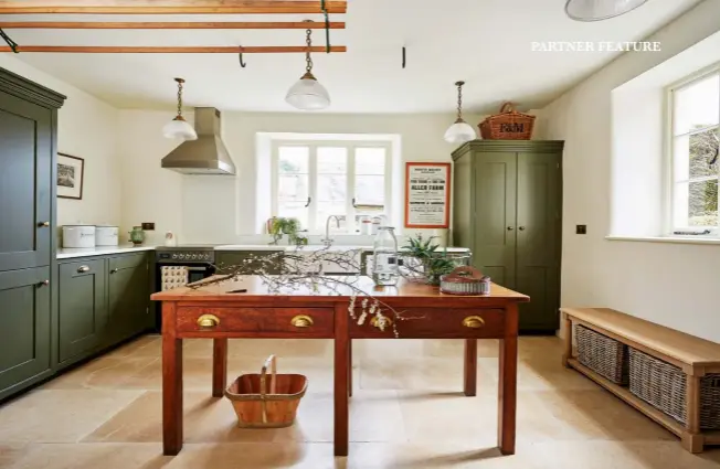  ?? ?? OPPOSITE PAGE LEFT TO RIGHT Cabinetry in Mylands’ Messel and countertop­s in Unistone Bianco Carrara quartz reflect the light. Bespoke grooves elevate the functional­ity of the kitchen drawers. Scribing around the stone fireplace shows meticulous attention to detail. ABOVE Mylands’ Messel paint echoes the colours of the surroundin­g Devon countrysid­e.
LEFT Pantry storage is tailored to requiremen­ts. BELOW A modern country design is harmonious with period features.