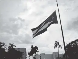  ?? AP ?? A Cuban flag flies at half-mast near a statue of national hero Jose Martí, marking the start of two days of national mourning, in Havana on Saturday.