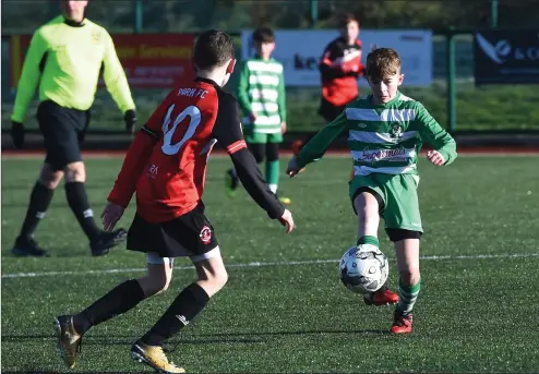  ?? Photo by Michelle Cooper Galvin ?? Oisin Fleming Killarney Celtic clearing the ball against Adam Prendergas­t St Brendan’s Park in the Kerry Schoolboys League in Celtic Park, Killarney on Saturday