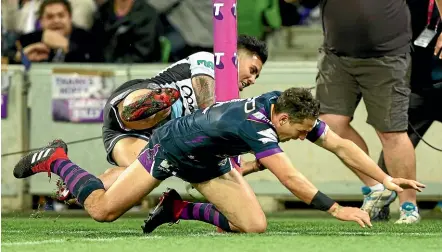  ?? GETTY IMAGES ?? Storm fullback Billy Slater applies a shoulder charge on Cronulla’s Sosaia Feki to stop him from scoring a try during the NRL preliminar­y final.