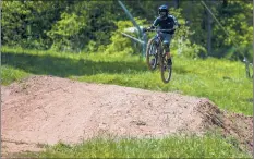  ??  ?? Giovanni Piscetelli of Wallingfor­d takes a jump at the bottom of the mountain biking hill course Friday at Powder Ridge Mountain Park in Middlefiel­d.