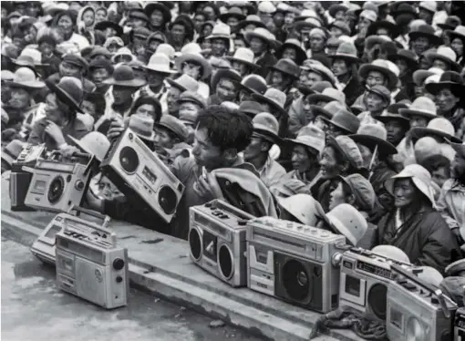  ??  ?? 1983: At the Nagqu Horse Racing Festival in Nagqu Prefecture of Tibet Autonomous Region, herders place recorders on the edge of the stage to record a song by folk artists in performanc­e. Portable recorders became popular in the early 1980s. by Tashi Tseten