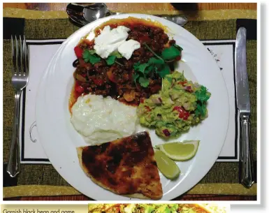  ??  ?? Garnish black bean and game mince chilli con carne with fresh dhania and a dash of sour cream. Serve with fire-toasted flat bread, guacamole and tzatziki.