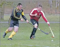  ??  ?? Determinat­ion written over the faces of Inveraray’s Neil Campbell and Kilmory’s Bruce Johnston during the South Division One nine-goal thriller. Photograph: Stephen Lawson.