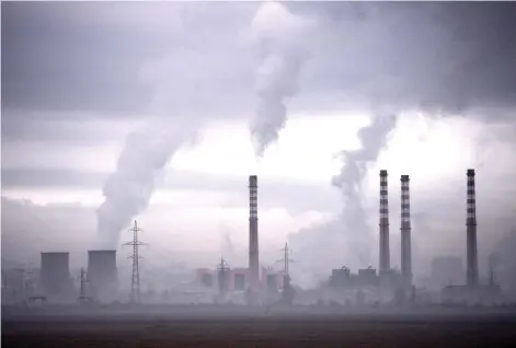  ?? — AFP file photo ?? Photo shows smoke rising from stacks of a thermal power station in Sofia, Bulgaria. A draft statement of the COP26 summit called on nations to ease their reliance on fossil fuels as talks entered their final hours Friday without any sign of delivering the emissions cuts needed to limit global warming to 1.5 degrees Celsius