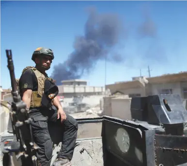  ?? (Ahmed Jadallah/Reuters) ?? AN IRAQI counterter­rorism soldier sits on top of his armored vehicle yesterday during a battle with Islamic State, in western Mosul.