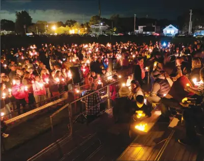  ?? Photos by Joseph B. Nadeau ?? Several hundred people packed the stands and the grass at Barry Field on Friday night, attending a candleligh­t vigil for Woonsocket’s Ricky Unwin, who died Wednesday. A prominent community member, Unwin was a Woonsocket High School graduate, along with...