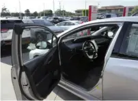  ?? JIM WILSON/THE NEW YORK TIMES ?? A used Toyota Prius, long the standard-bearer of hybrid cars, is shown in October at an auto dealership in Oakland, Calif.