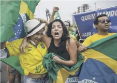  ??  ?? 0 Supporters of Brazil’s presidenti­al candidate Jair Bolsonaro