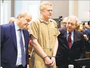  ?? Joshua Boucher Pool Photo ?? ALEX MURDAUGH, f lanked by his attorneys, was sentenced last week to two consecutiv­e life terms in prison for the shooting deaths of his wife, Maggie, and son Paul.