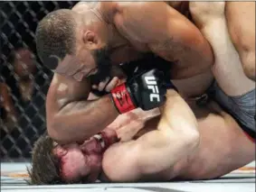  ?? JEFFREY MCWHORTER — THE ASSOCIATED PRESS ?? Tyron Woodley, top, elbows Darren Till in the face during their welterweig­ht title mixed martial arts bout at UFC 228 on Saturday in Dallas. Woodley won by submission.