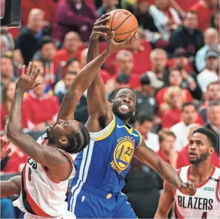  ?? TROY WAYRYNEN/USA TODAY SPORTS ?? Warriors forward Draymond Green blocks a shot by Trail Blazers forward Al-Farouq Aminu as Golden State completed a sweep of the Western Conference finals Monday.