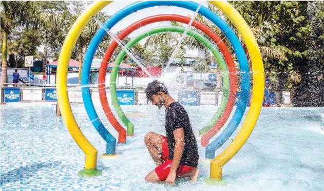  ?? Agence France-presse ?? ↑
A youth cools off in a pool during a hot summer day at a water park in New Delhi on Saturday.