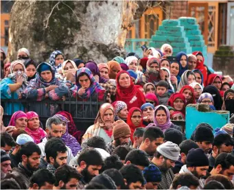  ?? (Danish Ismail/Reuters) ?? PEOPLE ATTEND the funerals yesterday of two men who according to local media were killed in a recent gun battle in Kashmir.