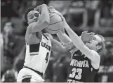  ?? JESSICA HILL/AP PHOTO ?? Wichita State’s Conner Frankamp, right, pressures UConn’s Jalen Adams during Saturday’s game.