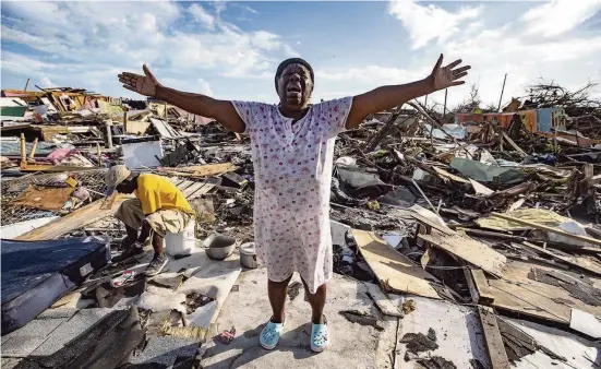  ?? AL DIAZ adiaz@miamiheral­d.com ?? Aliana Alexis stands Thursday on the concrete slab of what is left of her home in an area called The Mudd in Marsh Harbour on Great Abaco Island in the Bahamas.