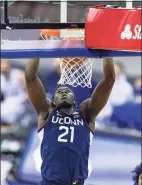  ?? John Peterson / Associated Press ?? UConn forward Adama Sanogo makes a dunk against Creighton in Saturday’s game.