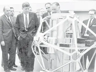  ?? SOURCE: SANDIA NATIONAL LABORATORI­ES ?? President John F. Kennedy inspects an atmospheri­c testing satellite package at Sandia National Laboratori­es during a 1962 visit to Albuquerqu­e. The president also visited Santa Fe and Los Alamos.