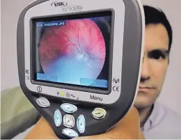  ?? KEVIN ROBINSON-AVILA/JOURNAL ?? VisionQues­t’s handheld camera provides a clear retinal image that the company can analyze with its software system to screen for eye damage.