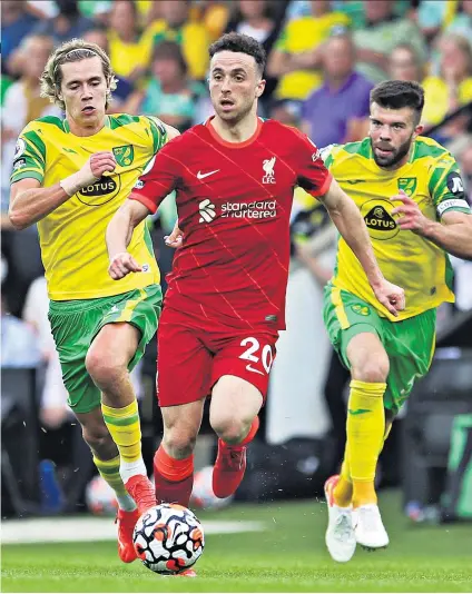  ??  ?? Opening the floodgates: Diogo Jota scored the first goal in a dominant display that will have pleased manager Jurgen Klopp (below left)