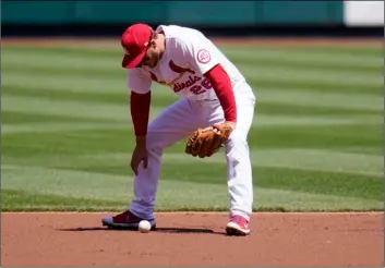  ?? AP Photo/Jeff Roberson ?? St. Louis Cardinals third baseman Nolan Arenado looks down after dropping a ball hit for a single by Washington Nationals’ Juan Soto during the third inning of a baseball game on Wednesday in St. Louis.