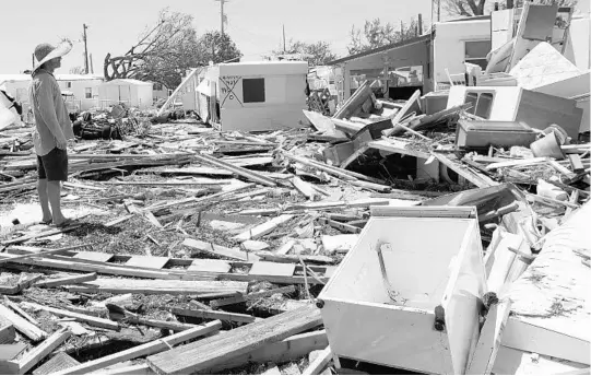  ?? SAUL LOEB/AFP/GETTY IMAGES ?? Bill Quinn surveys damage from Hurricane Irma at the Seabreeze Trailer Park in Islamorada. Residents were allowed to return to the parts of the Keys closest to Florida's mainland.