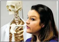  ?? AP/ROGELIO V. SOLIS ?? Kathryn Winfield stands next to the medical skeleton she worked on at Meridian Community College in Mississipp­i. She now works at a nursing home earning more than $13 an hour.