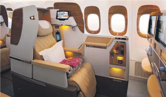  ??  ?? The business class seats on Emirates’ Boeing 777-200LR are laid out in a 2-2-2 configurat­ion and recline into flat beds