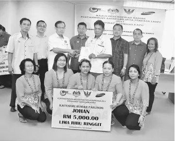  ??  ?? Jamit (back third left) with winners from Rumah Bengau. On his left is Kapit Resident Joseph Belayong Punan.