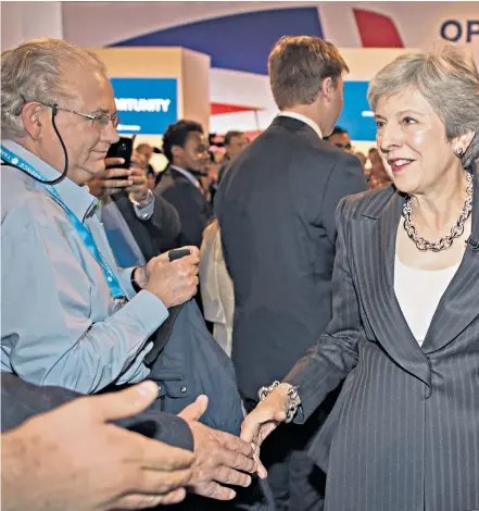  ??  ?? Theresa May and her husband, Philip, among supporters after delivering her speech at the Conservati­ve Party annual conference in Birmingham yesterday