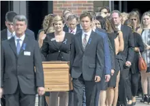  ?? BRYAN WOOLSTON/THE ASSOCIATED PRESS ?? The casket of Otto Warmbier is carried from Wyoming High School followed by his father, Fred Warmbier, centre with bowed head, after his funeral on Thursday in Wyoming, Ohio.