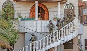  ?? (AFP) ?? Israeli forces carry out a raid on a house in the town of Rummanah, near the flashpoint town of Jenin in the occupied West Bank on Sunday