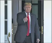  ?? AP/SUSAN WALSH ?? President Donald Trump watches Chilean President Sebastian Pinero leave the White House after a visit Friday. Trump also signed a spending bill Friday that averted a government shutdown.