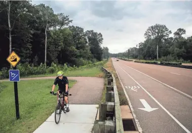  ?? COMMERCIAL APPEAL FILE PHOTO ?? A cyclist rides his bike on the Wolf River Greenway off Wolf River Boulevard in Germantown in 2017.