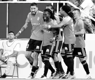  ?? COURTESY OF CONCACAF.COM ?? Christian Alba (left) of the Dominican Republic’s Cibao FC celebrates with teammates after scoring against Violette of Haiti in the first Group A Concacaf Flow Caribbean Club Championsh­ip match on Friday.