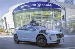  ?? Allen J. Schaben Los Angeles Times ?? A WAYMO TAXI makes a stop near Crypto.com Arena in downtown Los Angeles this week. The vehicle is equipped with lidar, cameras, radar and an AI platform.