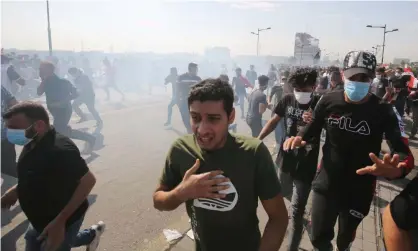  ?? Photograph: AFP/Getty Images ?? Iraqi protesters run for cover.