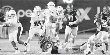  ?? RALPH NOTARO/COURTESY ?? Devin “Motor” Singletary (5) carries the ball against Old Dominion in Saturday’s game. He finished the game with 194 yards and two TDs.