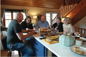  ?? The Associated Press ?? ■ Doug Whitney, center, eats breakfast with his family on Nov. 5, 2022, in Manson, Wash. Whitney inherited the same gene mutation that gave Alzheimer’s disease to his mother, brother and generation­s of other relatives by the unusually young age of 50. Doug is a healthy 73, his mind still sharp. Somehow, he escaped his genetic fate.