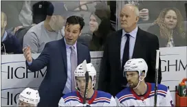  ?? GENE J. PUSKAR — THE ASSOCIATED PRESS ?? Rangers head coach David Quinn, standing at left, talks with assistant Lindy Ruff, standing at right, during a game against the Penguins on Feb. 17, 2019. Ruff has been hired as the Devils’ next head coach.