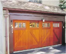  ?? ALEXANDER B. ?? If you’re stuck with a builder-grade garage door, upgrading to a more stylish model is worth considerin­g.