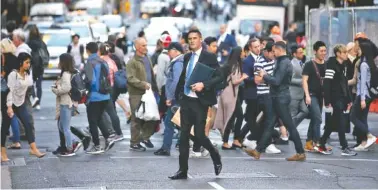  ?? PHOTO BY RICK RYCROFT/AP ?? People move about as the working day ends in Sydney. Australia’s economy has grown for 26 years without a recession. Some say immigratio­n is behind the country’s economic success.