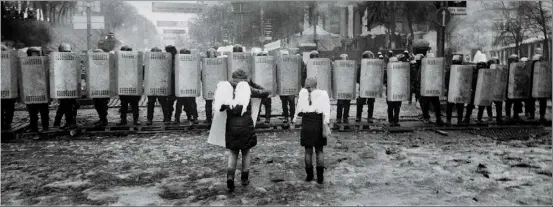  ??  ?? Top Young Ukrainians confrontin­g police in Kiev, from the series Barricades 2009-14 by Pavel Wolberg