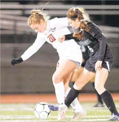  ?? DAVID GARRETT/SPECIALTOT­HE MORNING CALL ?? Pennridge’ s Liv Grenda gets her foot on the ball ahead of Parkland’s Dani Marsteller on Tuesday. Pennridge beat Parkland 4-3 in overtime of the 4A girls soccer semifinals at Grand View Health Stadium.