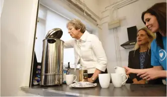  ?? (Reuters) ?? LOOKING FOR the right combinatio­n: British Prime Minister Theresa May visits a charity in London yesterday.