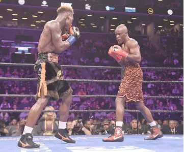  ?? — AFP photo ?? Jermell Charlo and Tony Harrison fight during their WBC Super Welterweig­ht Championsh­ip bout at Barclays Center in the Brooklyn borough of New York City.