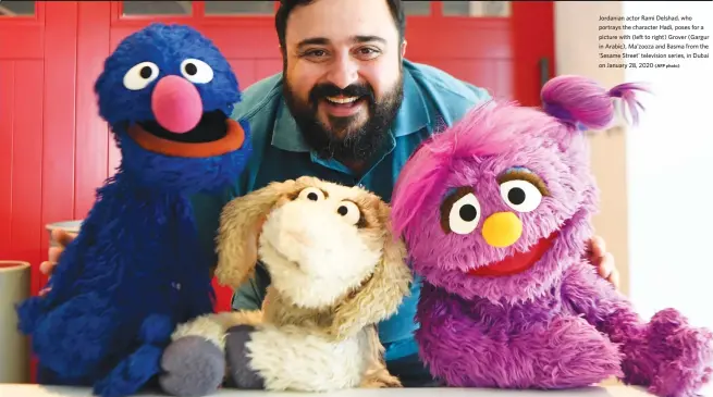  ?? (AFP photo) ?? Jordanian actor Rami Delshad, who portrays the character Hadi, poses for a picture with (left to right) Grover (Gargur in Arabic), Ma’zooza and Basma from the ‘Sesame Street’ television series, in Dubai on January 28, 2020