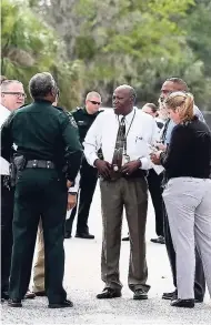  ?? AP ?? Authoritie­s confer near the scene of a shooting where they said there were multiple fatalities in an industrial area near Orlando, Florida, yesterday.